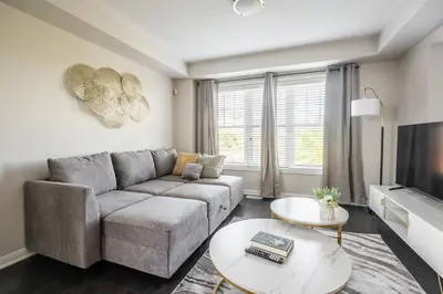 a living room with a couch and a tv at GlobalStay 3 Bedroom House with Parking Brampton in Brampton