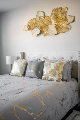 a bedroom with a bed with gold and silver pillows at GlobalStay 3 Bedroom House with Parking Brampton in Brampton