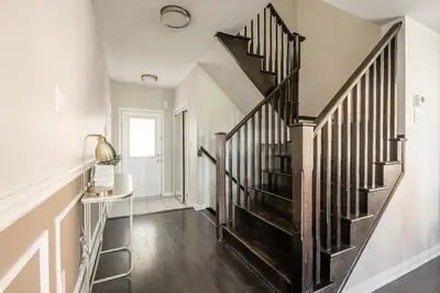 a staircase in a home with white walls and wooden floors at GlobalStay 3 Bedroom House with Parking Brampton in Brampton