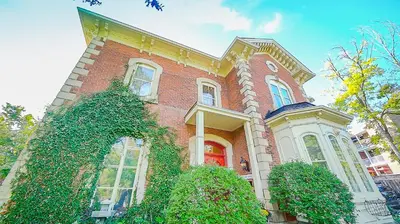 a large brick house with ivy growing on it at Norfolk Guest House Inn in Guelph