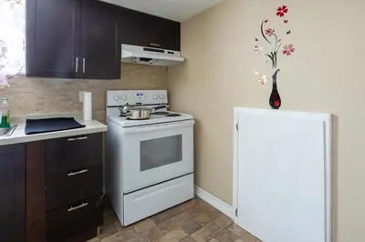 a kitchen with a white stove and a white refrigerator at Private room with TVnetflix and free parking in Pickering