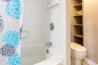 a bathroom with a toilet and a shower curtain at Private room with TVnetflix and free parking in Pickering