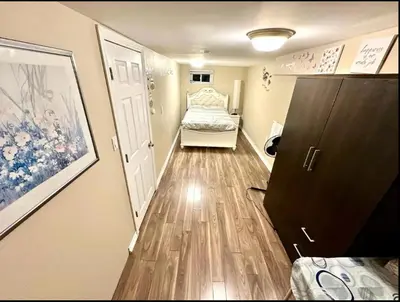 a hallway with a bedroom with a bed and a door at Private room with TVnetflix and free parking in Pickering