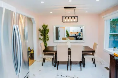 a dining room with a table and chairs at Riverfront Cottage Sauna Canoe Included Kids Playroom Nature Escape in Wasaga Beach
