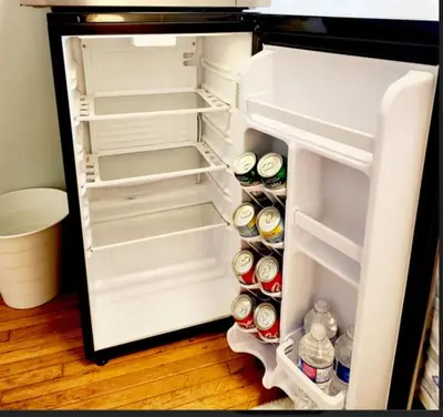 an open refrigerator filled with lots of drinks and food at Toronto Uptown 3 - Bus to Downtown in Toronto