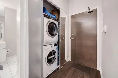 a laundry room with a washer and dryer at City Serenity 1 Bedroom with Balcony in Toronto