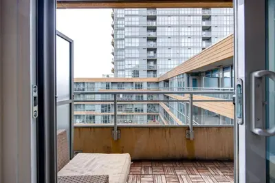 a balcony with a view of a tall building at City Serenity 1 Bedroom with Balcony in Toronto