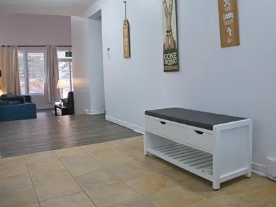 a living room with a white dresser with a black counter at Modern Townhome at Wintergreen Sauna Steps from Blue Mountain Village in Blue Mountains