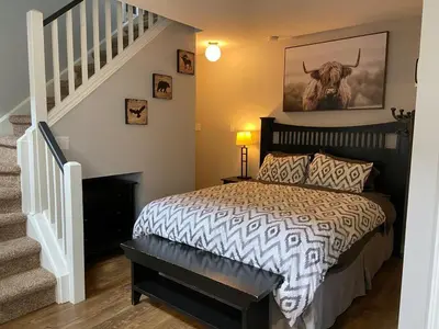 a bedroom with a bed with a cow on the wall at Blue Mountain Escape, WIFI, Base of North lift in Blue Mountains