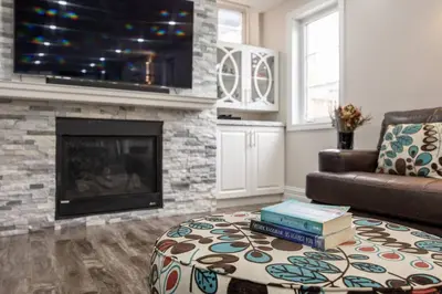 a living room with a couch and a fireplace at Walk-out Basement Apartment with Private Entrance in Brampton
