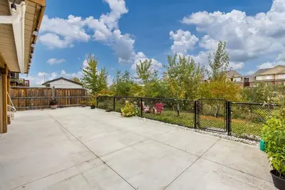 a patio with a black fence and a yard at Walk-out Basement Apartment with Private Entrance in Brampton