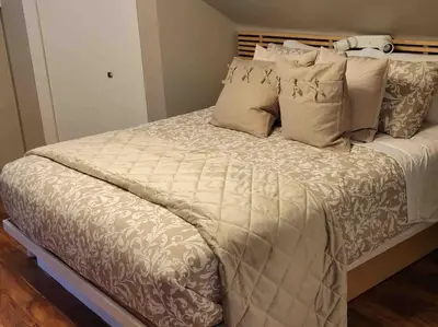 a large bed with white sheets and pillows at Anthropocene Jewel Cottage in Milton