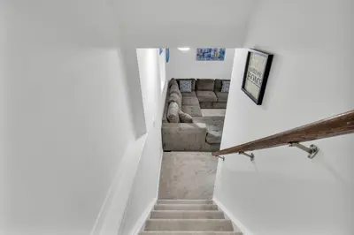 a stairway leading to a living room with a couch at Modern 1 Bedroom + Den in Cambridge in Cambridge