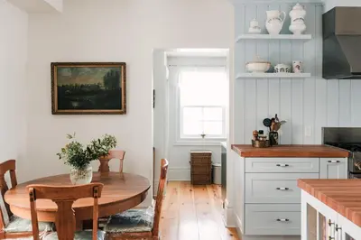 a kitchen with a wooden table and a dining room at Little Louis - A Princely Take on a County Getaway in Mountain View