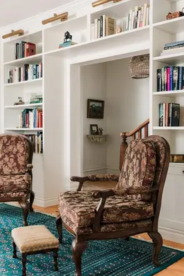 a living room with two chairs and a book shelf at Little Louis - A Princely Take on a County Getaway in Mountain View