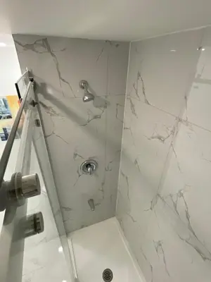 a bathroom with a shower with white marble at Executive Apartment - 2BDR Parking Self-check in - Walkout basement Lower Unit in Mississauga