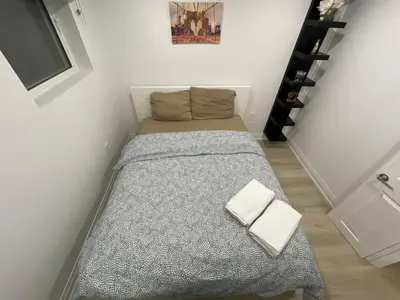 a small room with a bed with two white towels at Executive Apartment - 2BDR Parking Self-check in - Walkout basement Lower Unit in Mississauga