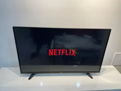 a television sitting on a table with the netflix sign on it at Executive Apartment - 2BDR Parking Self-check in - Walkout basement Lower Unit in Mississauga
