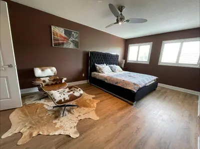 a bedroom with a bed and a chair at Beautiful Master bedroom unit with private washroom in Mississauga