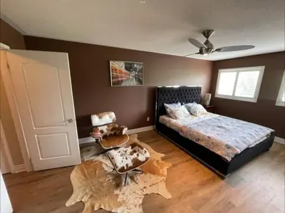 a bedroom with a bed and a wooden floor at Beautiful Master bedroom unit with private washroom in Mississauga