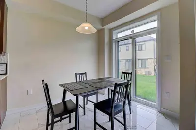 a dining room with a table and chairs and a window at Modern NEW Build in Caledonia in Caledonia