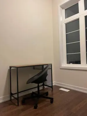 a desk with a chair in a room with a window at Modern NEW Build in Caledonia in Caledonia