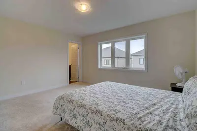 a bedroom with a bed and a window at Modern NEW Build in Caledonia in Caledonia