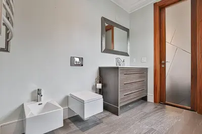 a white bathroom with a sink and a mirror at Luxurious Spa Retreat - Toronto Escape in Toronto