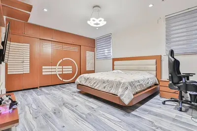 a bedroom with a bed and a desk and a chair at Luxurious Spa Retreat - Toronto Escape in Toronto