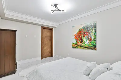 a bedroom with a bed and a painting on the wall at Luxurious Spa Retreat - Toronto Escape in Toronto