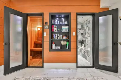 a room with an orange wall with a medicine cabinet at Luxurious Spa Retreat - Toronto Escape in Toronto