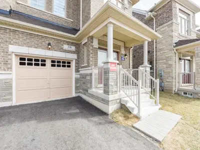 a brick house with a garage and a driveway at Stylish Home in Waterdown in Hamilton