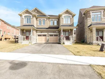 a large brick house with a large driveway at Stylish Home in Waterdown in Hamilton