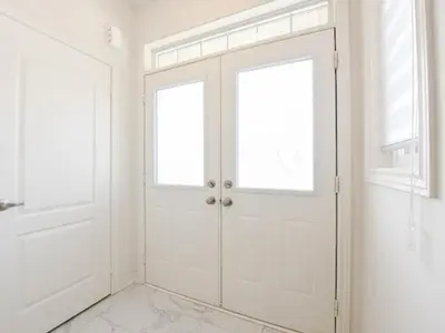 a white door with two windows in a white room at Stylish Home in Waterdown in Hamilton