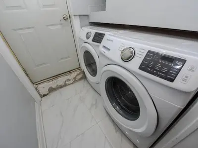 a white washer and dryer in a bathroom at Elegant Home in Mississauga in Mississauga
