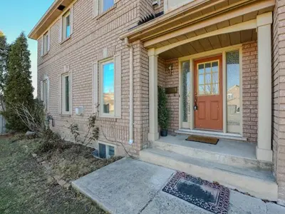 a brick house with a red door on it at Elegant Home in Mississauga in Mississauga