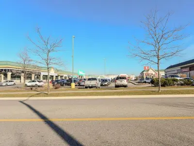 a street with cars parked in a parking lot at Elegant Home in Mississauga in Mississauga
