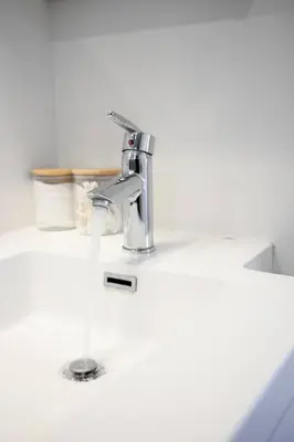 a sink with a faucet on a white counter at Chic 1-BR Condo; Parking included; Downtown Core in Toronto