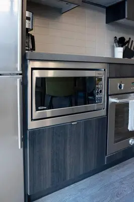 a kitchen with a microwave and a stove at Chic 1-BR Condo; Parking included; Downtown Core in Toronto