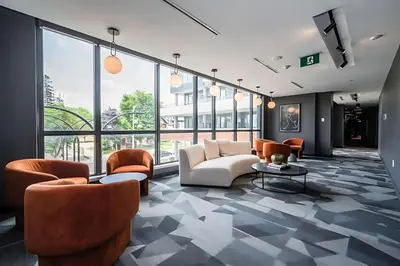 a lobby with couches and chairs in a building at Luxury 1BR King Bed Unit - Private Balcony in Kitchener