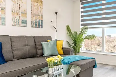 a living room with a couch and a table at Luxury 1BR King Bed Unit - Private Balcony in Kitchener