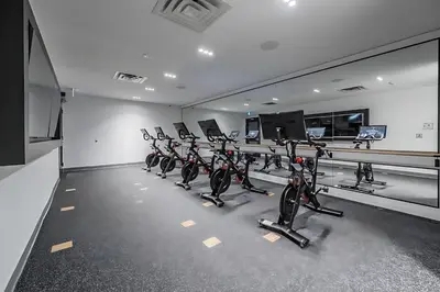 a row of exercise bikes in a gym at Luxury 1BR King Bed Unit - Private Balcony in Kitchener
