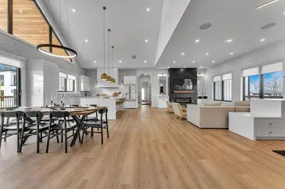 a large kitchen and dining room with a table and chairs at Sherkston Oasis - Hot Tub Soaks & Luxurious Escape in Port Colborne