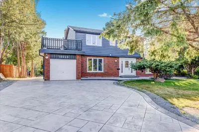 a house with a driveway and a garage at Stunning 7 Br RougeView Home with 2 Kitchens, 5 Bathrooms, Amazing Backyard & 8-Car Parking in Toronto