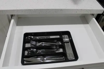 a tray of silver utensils sitting in a drawer at Comfyhome in Vaughan
