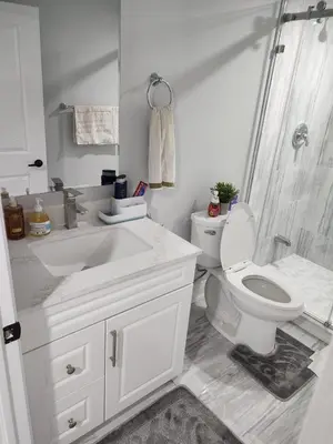 a bathroom with a toilet and a sink and a shower at SUITE A 2 Bedroom Apartment in Brampton