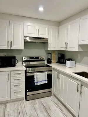 a kitchen with white cabinets and an oven at SUITE A 2 Bedroom Apartment in Brampton