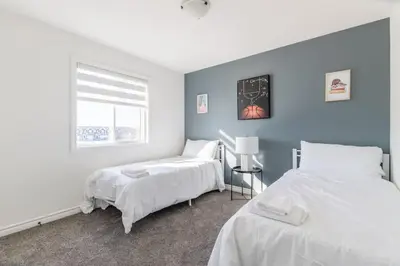 a bedroom with two beds and a window at Comfortable Lux, Sleeps 10, PingPong, Movie Room in London