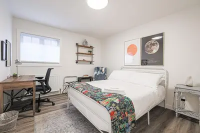 a bedroom with a bed and a desk and a desk at Downtown Oasis-2BR-Spa Bath-Pet Friendly, Free Parking in Toronto