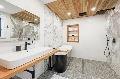 a bathroom with a white sink and a mirror at Downtown Oasis-2BR-Spa Bath-Pet Friendly, Free Parking in Toronto